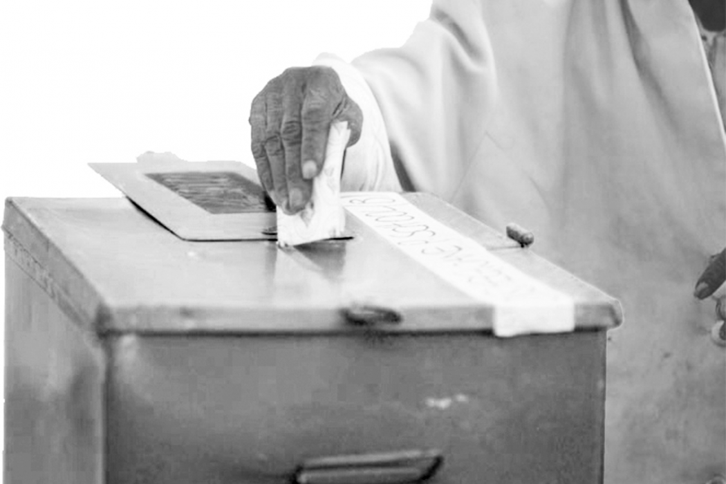 man voting in ballot box