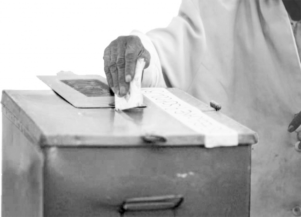 man voting in ballot box